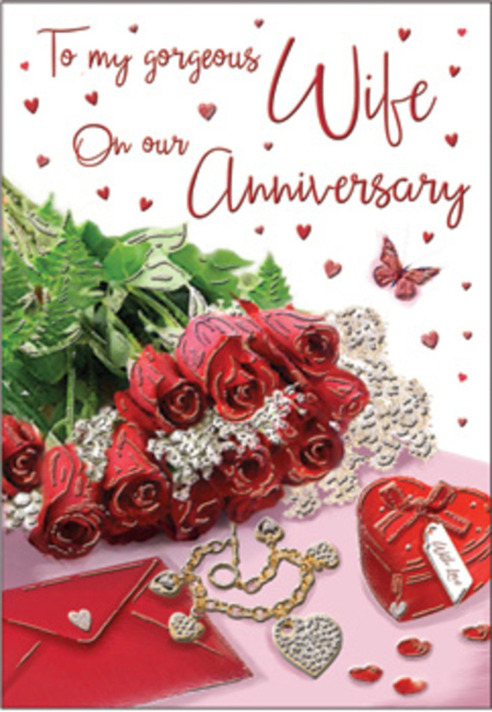 In this richly romantic anniversary image, a bouquet of classic red roses takes centre stage, their blooms full and luxuriant, arranged as though they have just been hand-tied in a small Kensal Green flower studio. Each petal folds over the next in deep scarlet layers, creating a sense of comfort and familiarity that long-time couples often cherish. Around the roses winds a collar of lush green foliage, the leaves glossy and fresh, echoing the look of arrangements delivered to homes and cafés along College Road or near Kensal Rise. The flowers and card are placed on a softly lit surface, where thin lace-like textures and delicate heart motifs draw the eye. A jewellery set lies nearby, its metallic surfaces catching hints of gold and silver under the light, suggesting a treasured anniversary gift waiting to be worn. A vivid red box, likely holding a ring or necklace, sits partly open, its rich colour mirroring the roses and reinforcing the sense of occasion. Scattered trinkets and tiny decorative hearts introduce a gentle sparkle, while a butterfly detail adds a whimsical note, as if love itself had taken flight and landed among the keepsakes. The scripted message on the card flows elegantly, its curves and flourishes echoing the shapes of the rose petals. The mix of textures-velvet-like flowers, smooth card, cool metal, and soft fabric-creates an atmosphere that feels like a warm embrace. The entire scene evokes the experience of presenting an anniversary surprise after a stroll around the local streets of Kensal Green, where everyday surroundings are transformed by thoughtful gestures and enduring affection.